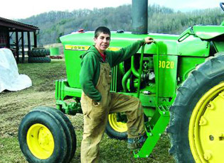 Matt Demattio, 16, of Tuscarawas gets ready to use the John Deere tractor he purchased recently with a USDA loan. Photo by Barb Limbacher of the Times Reporter.
