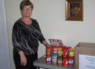 Veronica Ferguson, Director of Franklin Cooperative Ministries, unpacks peanut butter collected by the Virginia Southampton County FSA.