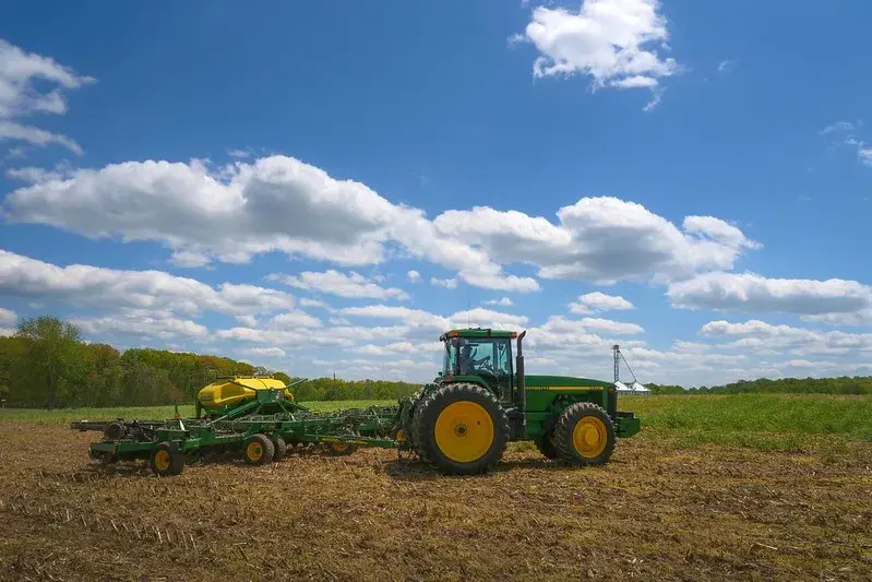 A farmer plants soybeans