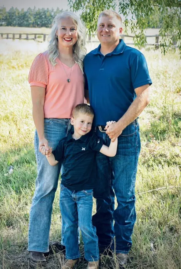 Photo of a couple with their child outside